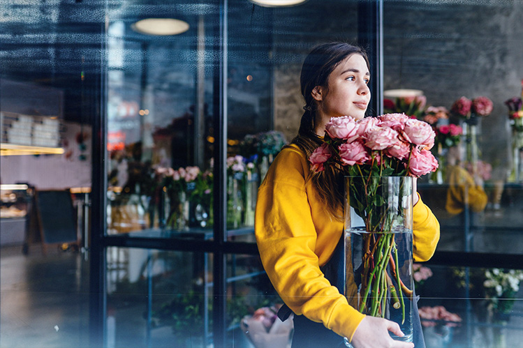 Flower Store Owner holding flower vase