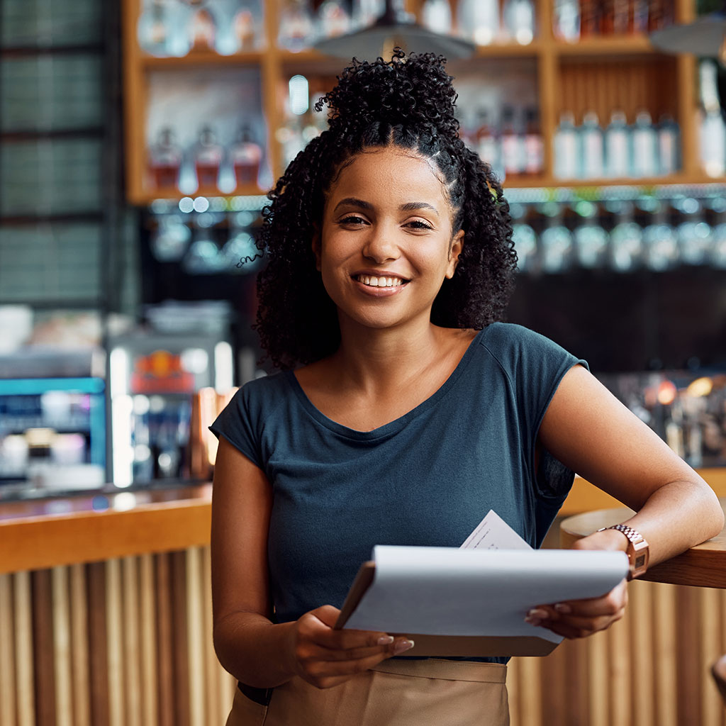 happy small business owner and paperwork